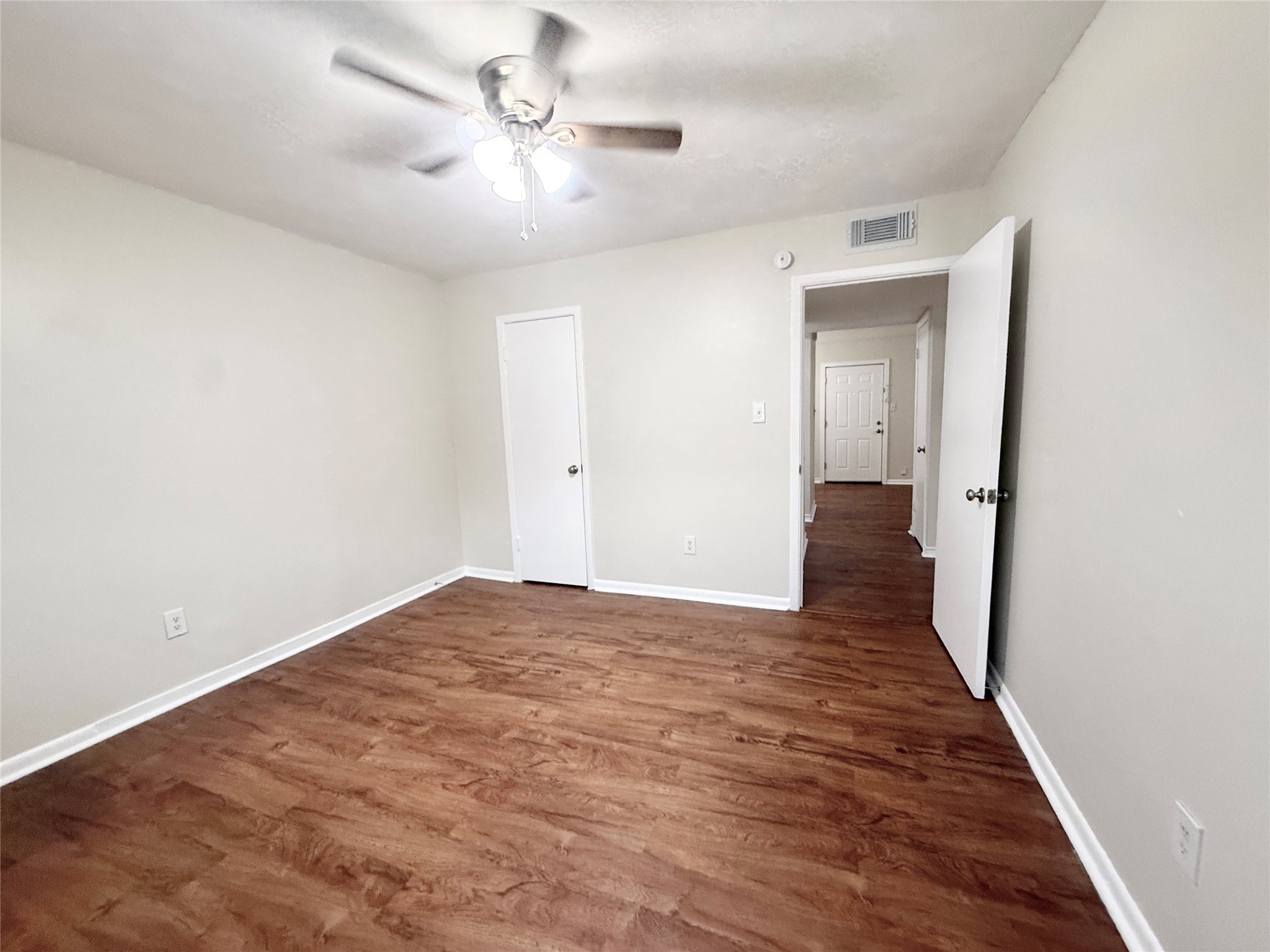 321 East Cedar Street, Unit 7 Angleton, TX 77515 - Photo 16 of 16 a view of a big room with wooden floor and a ceiling fan