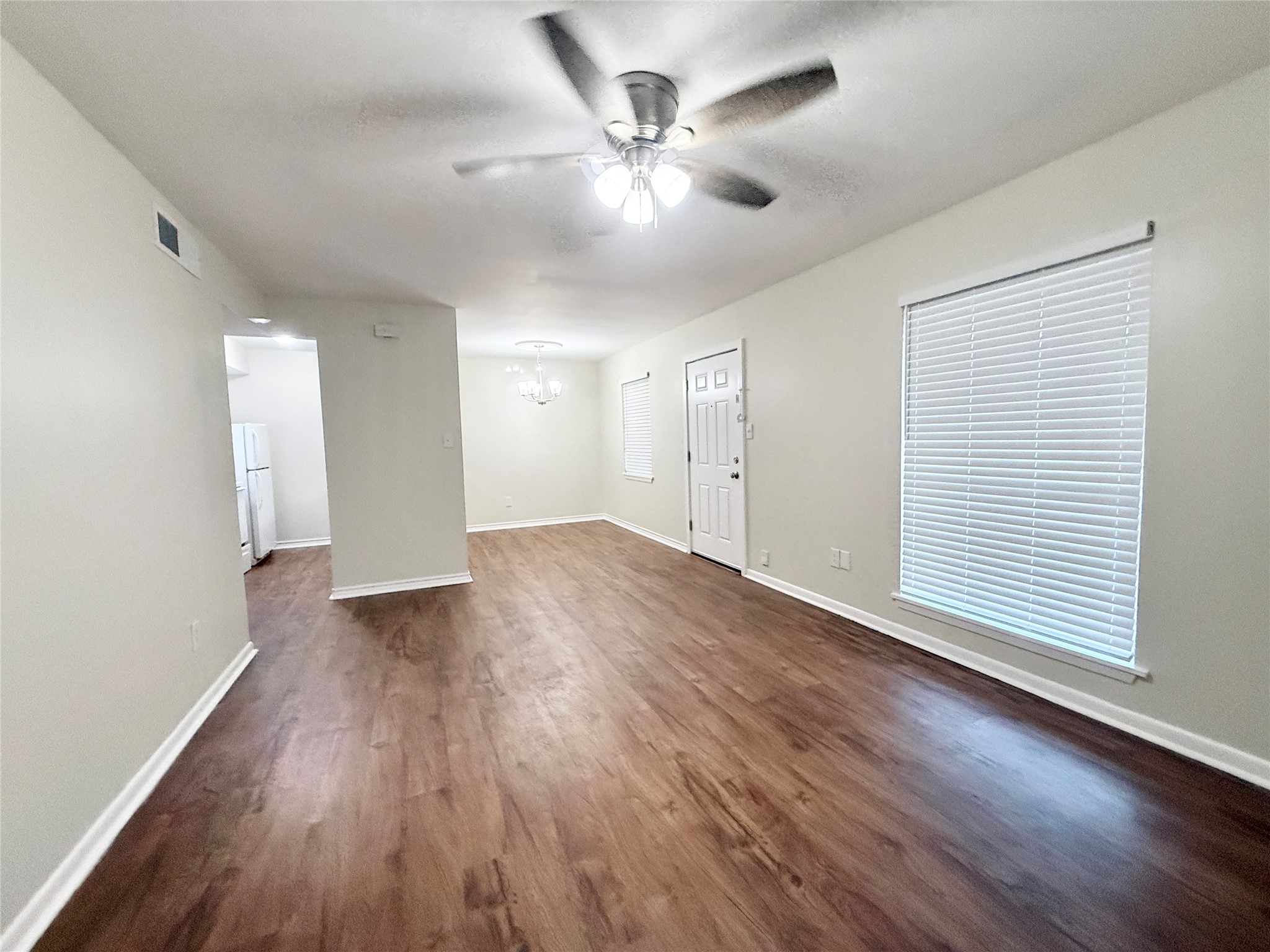 321 East Cedar Street, Unit 7 Angleton, TX 77515 - Photo 3 of 16 wooden floor in an empty room with a window