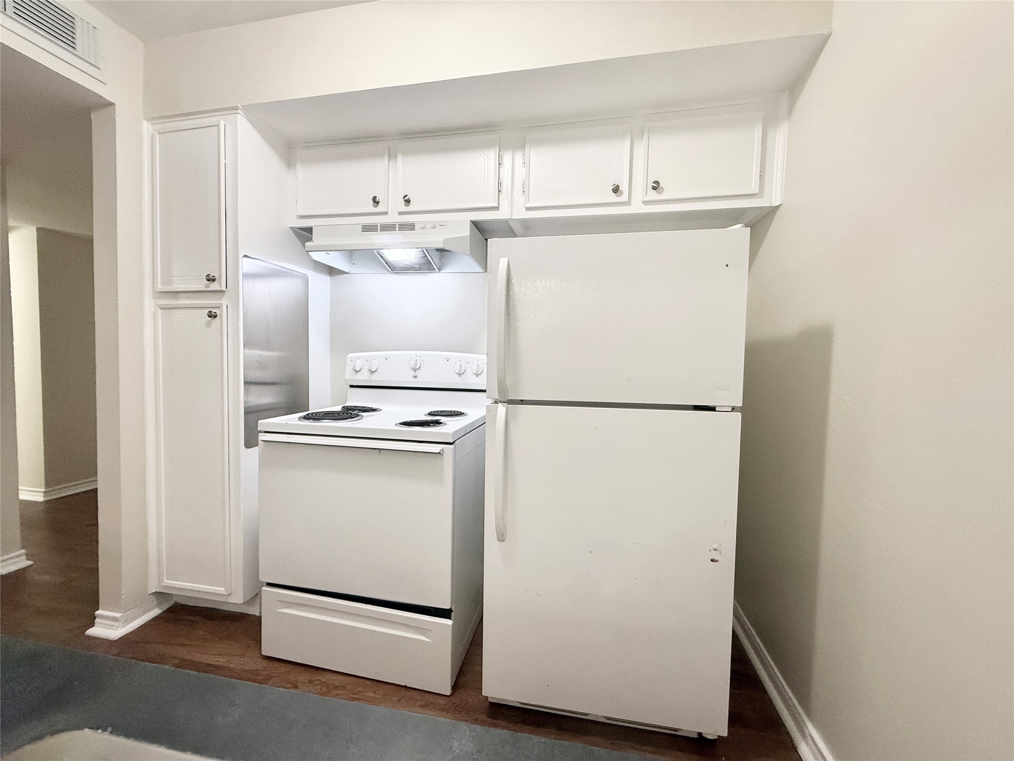 321 East Cedar Street, Unit 7 Angleton, TX 77515 - Photo 5 of 16 a white refrigerator freezer and a stove sitting inside of a kitchen