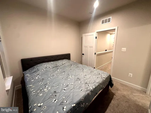a bedroom with a bed and cabinets