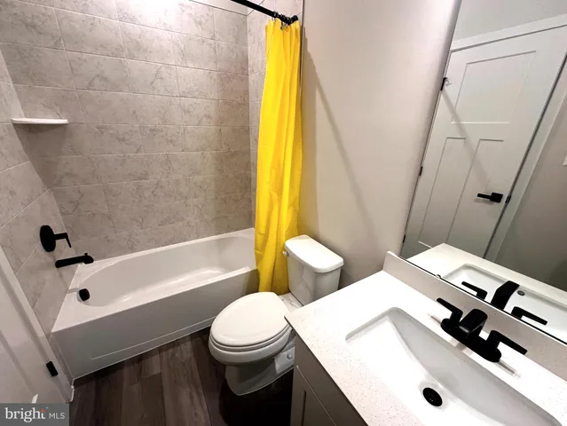 a bathroom with a sink a toilet and a bathtub
