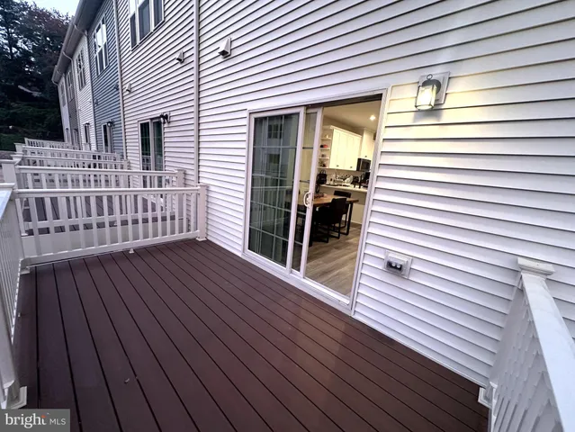 a view of a house with wooden deck