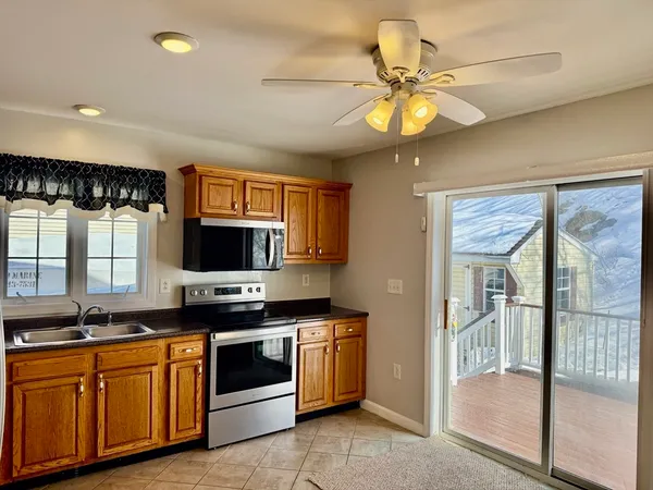 a kitchen with stainless steel appliances a stove a sink and a refrigerator