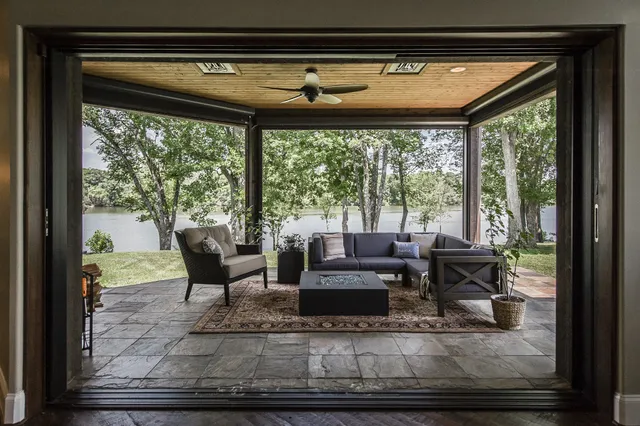 a living room with furniture and a floor to ceiling window