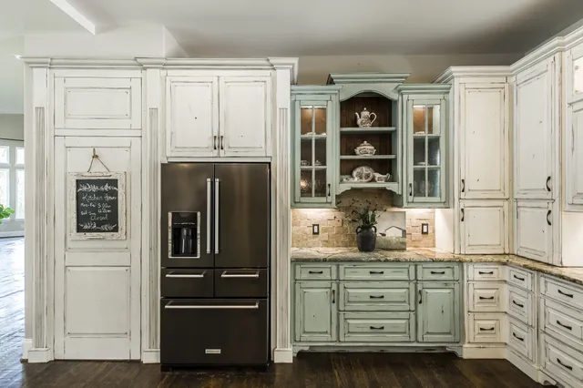 a kitchen with stainless steel appliances granite countertop a refrigerator and a stove top oven