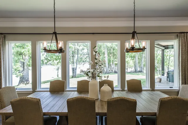 a view of a dining room with furniture large windows and wooden floor