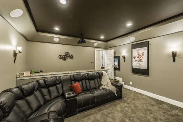 a media room with furniture and a projector screen