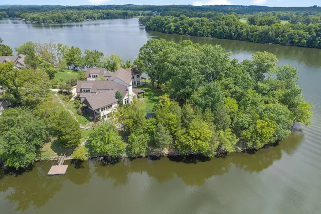 an aerial view of a houses with a lake view