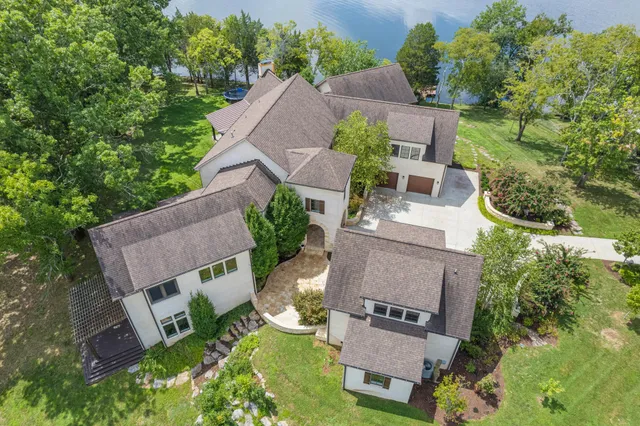 an aerial view of a house with garden space and street view
