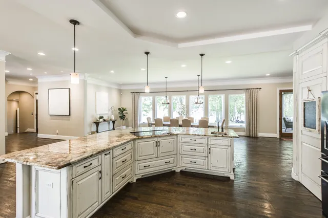 a large kitchen with granite countertop lots of counter space and window