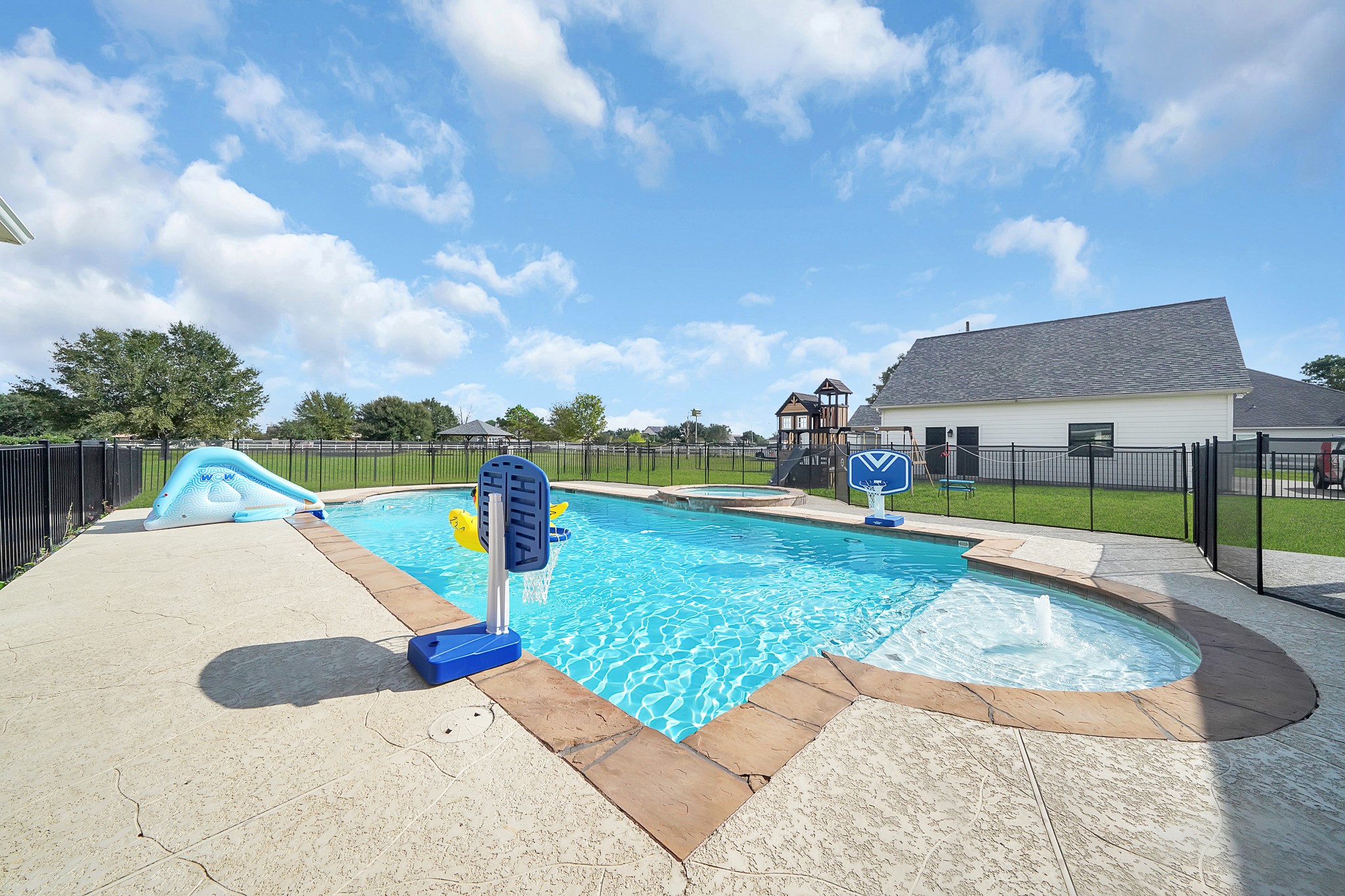 4730 Pitts Road Katy, TX 77493 - Photo 22 of 36 Enjoy your own private oasis featuring a spacious in-ground pool with secure fencing and generous patio area for relaxing and entertaining.