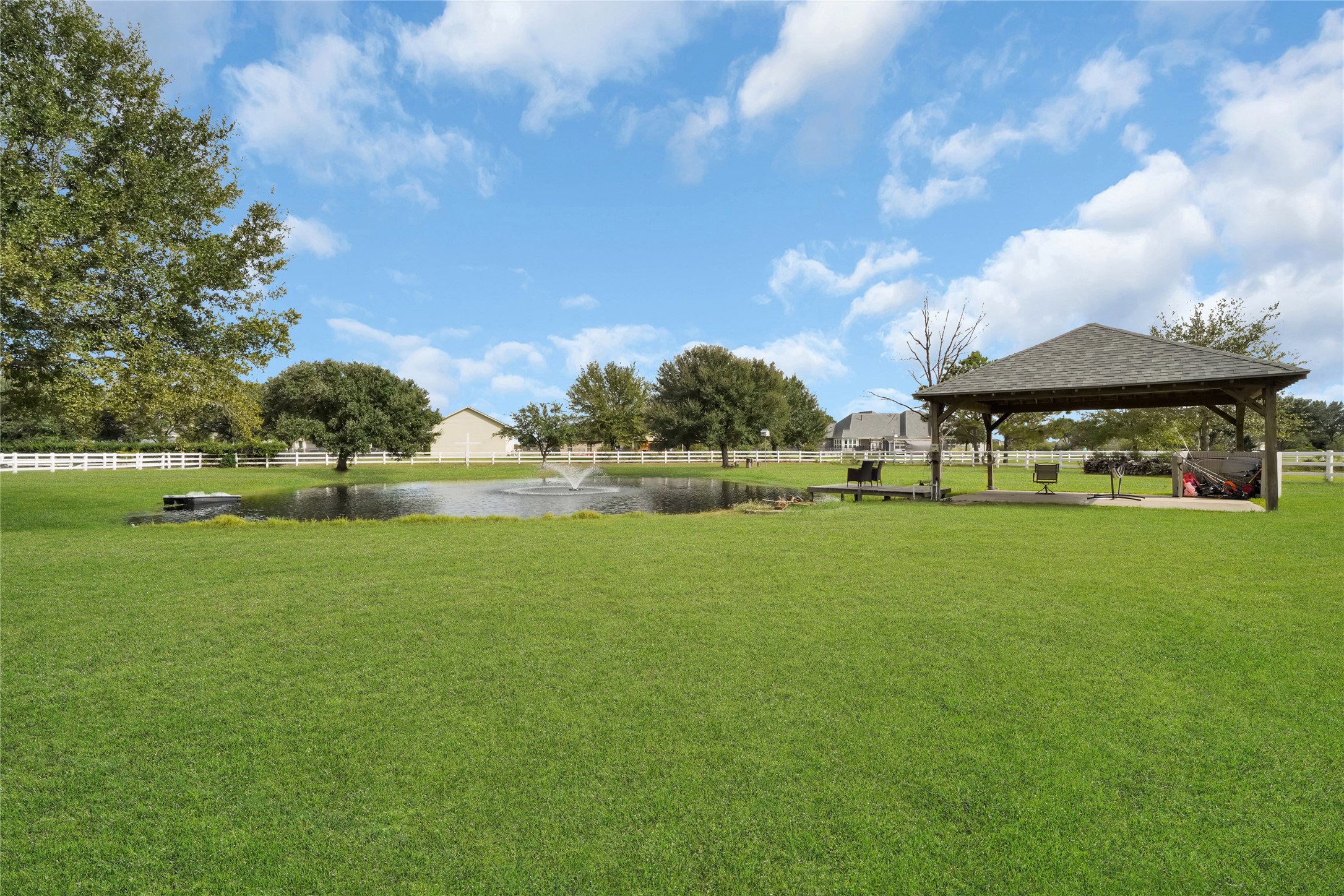 4730 Pitts Road Katy, TX 77493 - Photo 28 of 36 Charming pond-side retreat with a picturesque deck and shaded pavilion, perfect for hosting and relaxation.