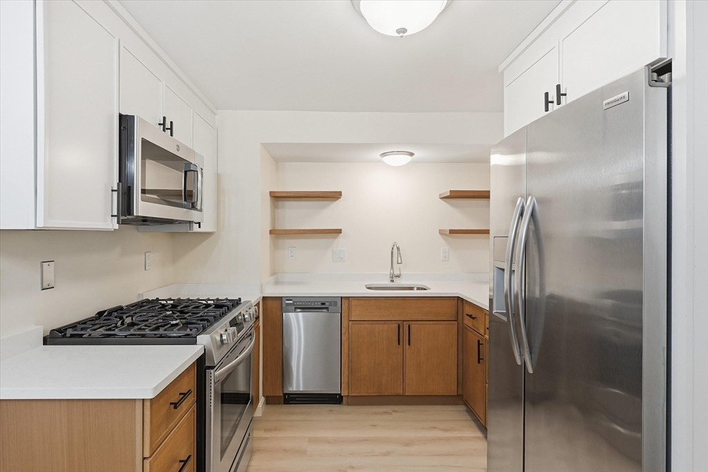 237 Main Street, Unit A4 Reading, MA 01867 - Photo 1 of 22 a kitchen with a sink stove and refrigerator