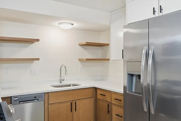 a kitchen with a refrigerator and a sink
