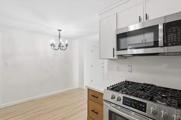 a kitchen with stainless steel appliances a stove and microwave