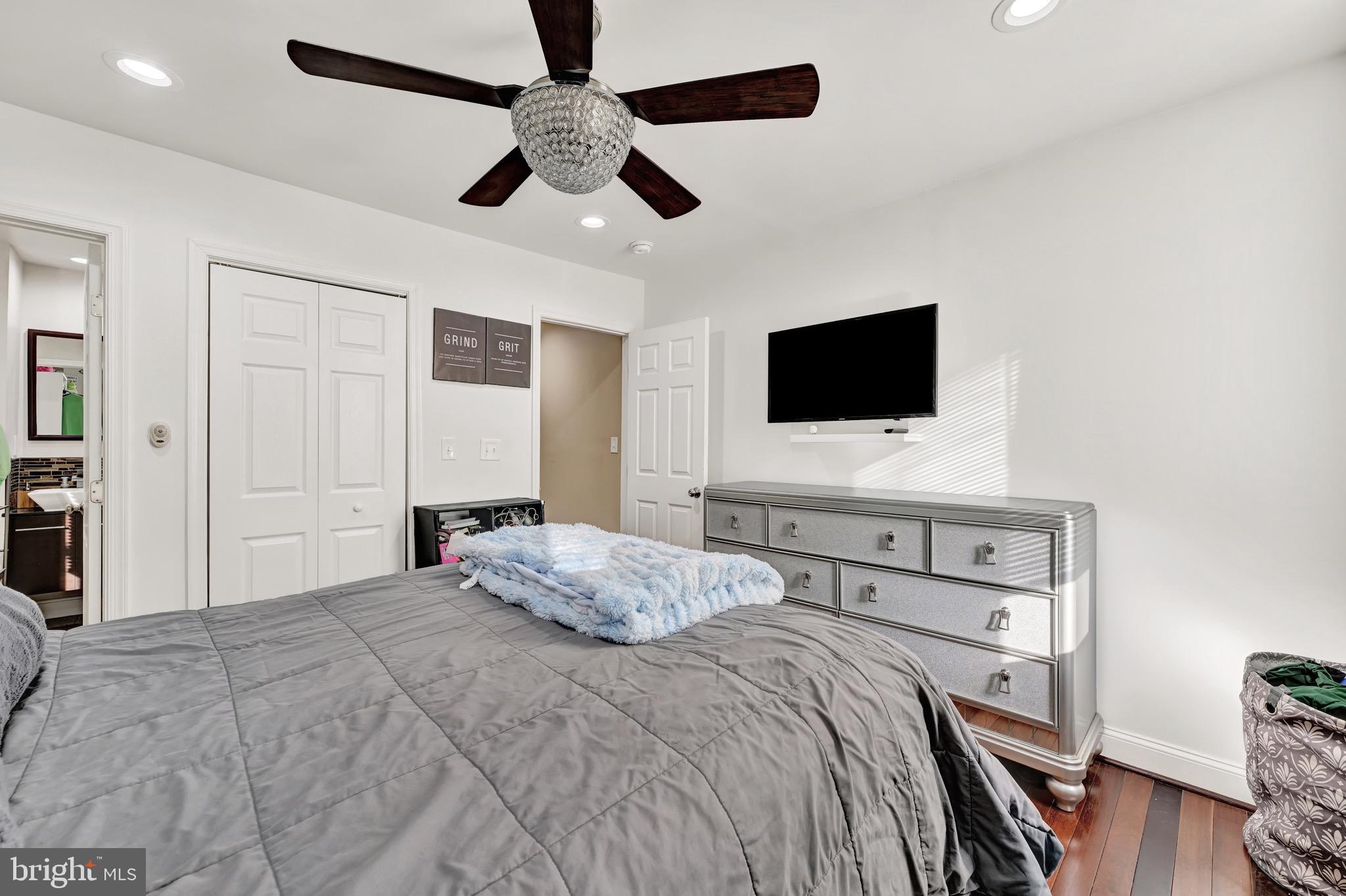 1401 East Lanvale Street Baltimore, MD 21213 - Photo 13 of 17 a bedroom with a bed and a flat screen tv