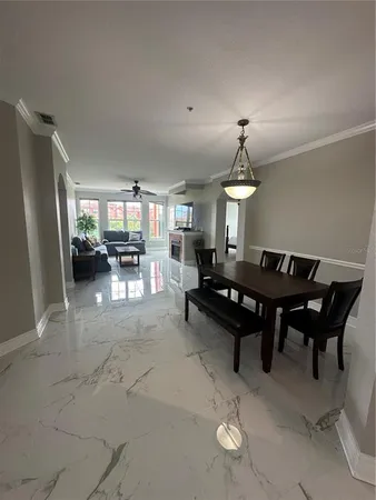 a living room with furniture a rug and a chandelier