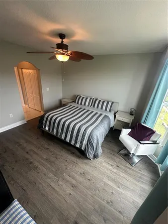 a bedroom with a bed and wooden floor
