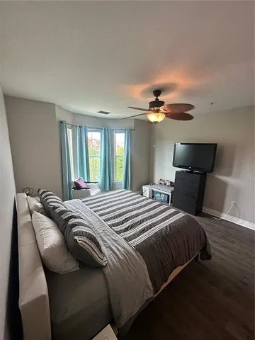 a spacious bedroom with a bed and a chandelier