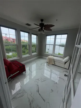 a living room with furniture and a floor to ceiling window