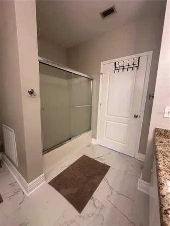 a bedroom with bed and a chandelier
