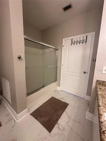 a bedroom with bed and a chandelier