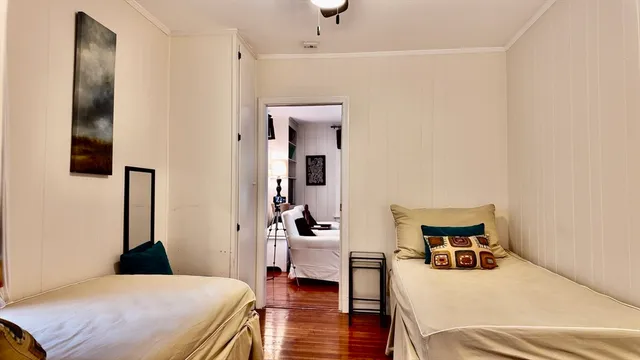 a bedroom with a bed and wooden floor