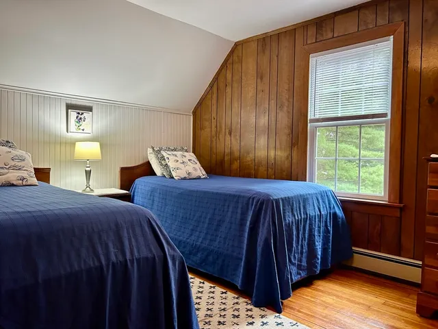 a bedroom with bed and window
