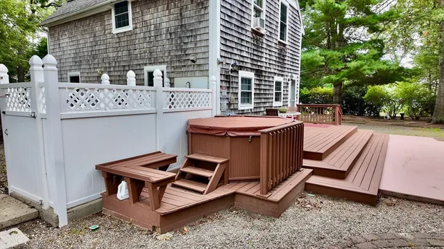 a view of a chairs and table in backyard