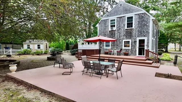 a view of a patio with table and chairs under an umbrella