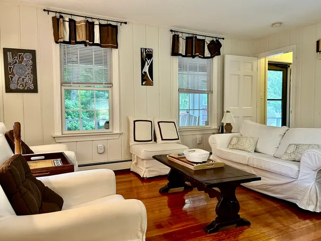 a living room with furniture a rug and a window