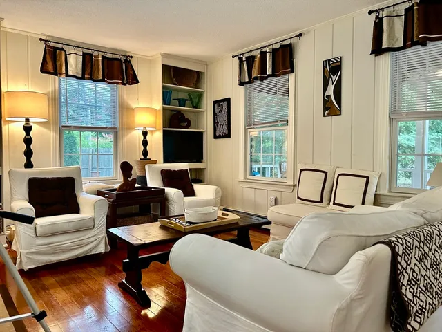 a living room with furniture fireplace and flat screen tv