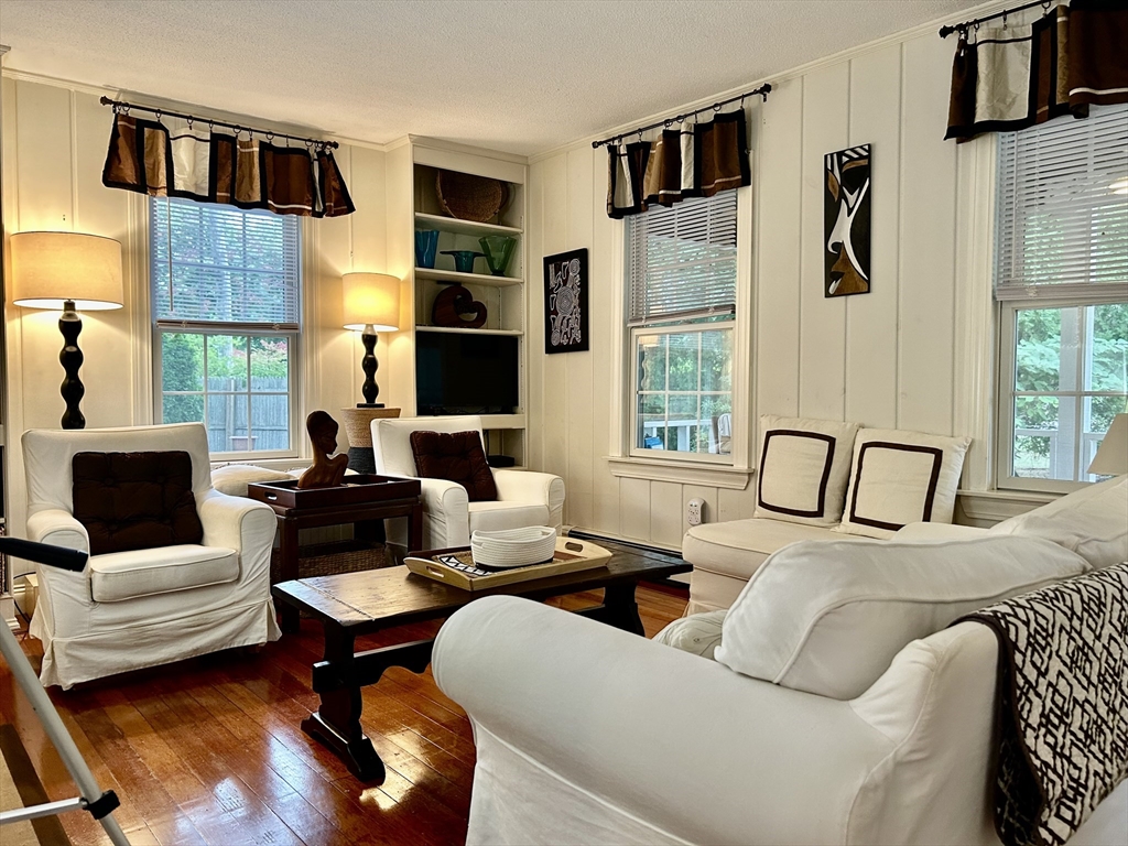 19 Rolling Acres Lane Falmouth, MA 02536 - Photo 3 of 27 a living room with furniture fireplace and flat screen tv
