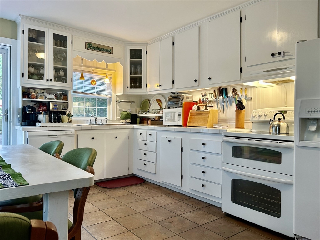 19 Rolling Acres Lane Falmouth, MA 02536 - Photo 6 of 27 a kitchen with stainless steel appliances a stove a sink and a cabinets