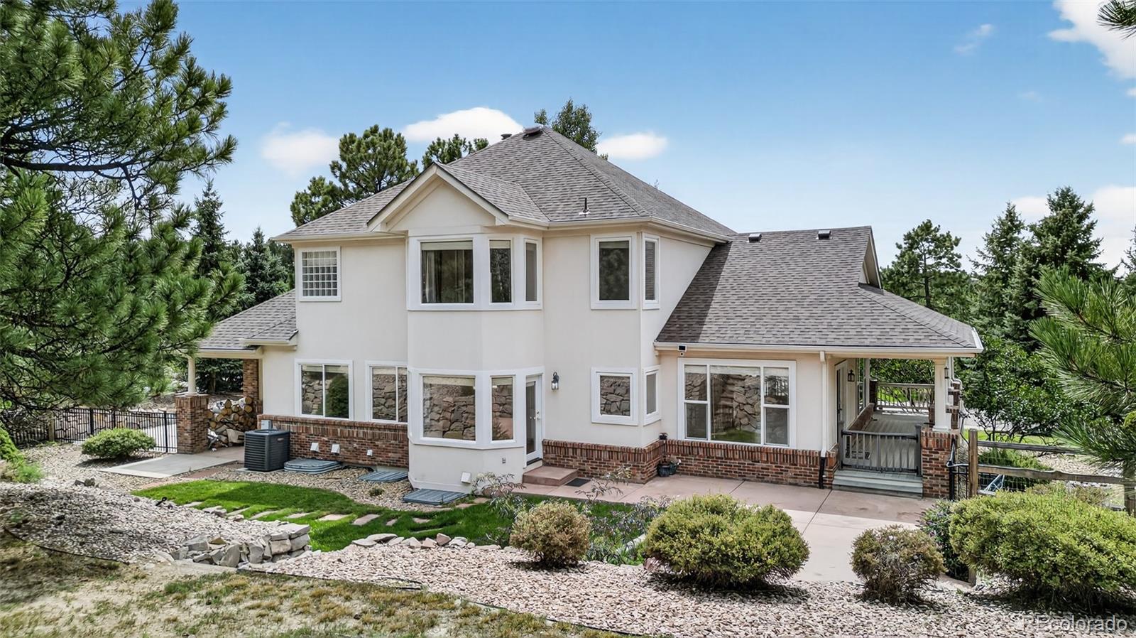 8389 Owl Roost Court Parker, CO 80134 - Photo 11 of 50 a front view of a house with a garden and porch