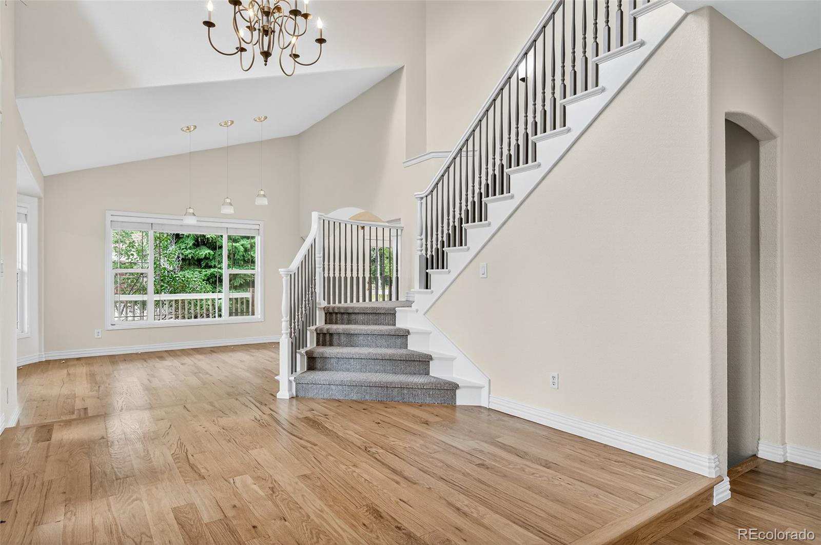8389 Owl Roost Court Parker, CO 80134 - Photo 13 of 50 a view of entryway and hall with wooden floor