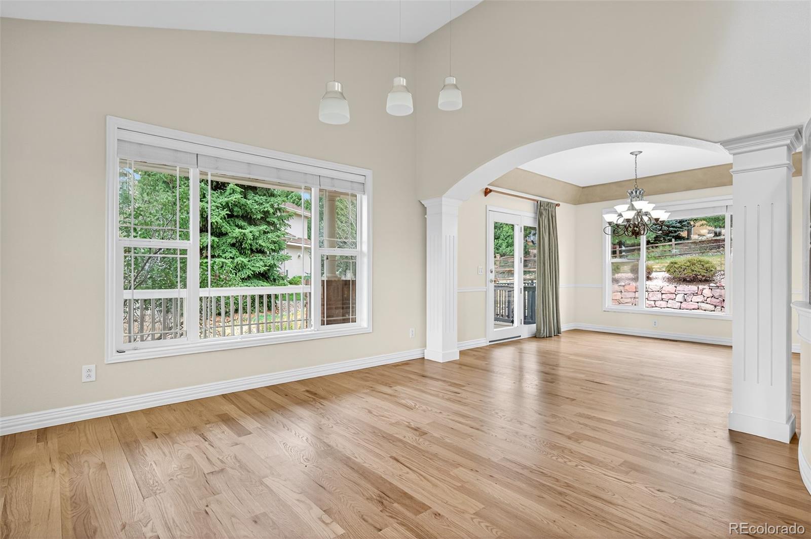 8389 Owl Roost Court Parker, CO 80134 - Photo 16 of 50 a view of an empty room with wooden floor and a window