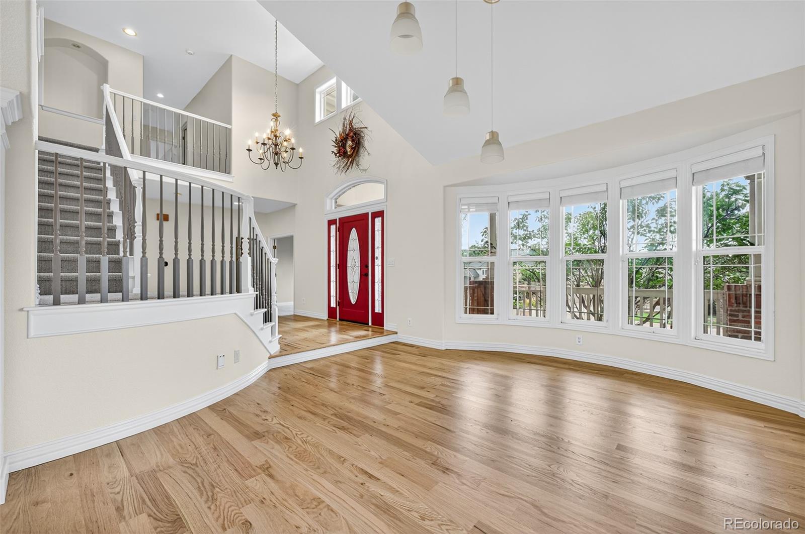 8389 Owl Roost Court Parker, CO 80134 - Photo 18 of 50 a view of an empty room with wooden floor and a window