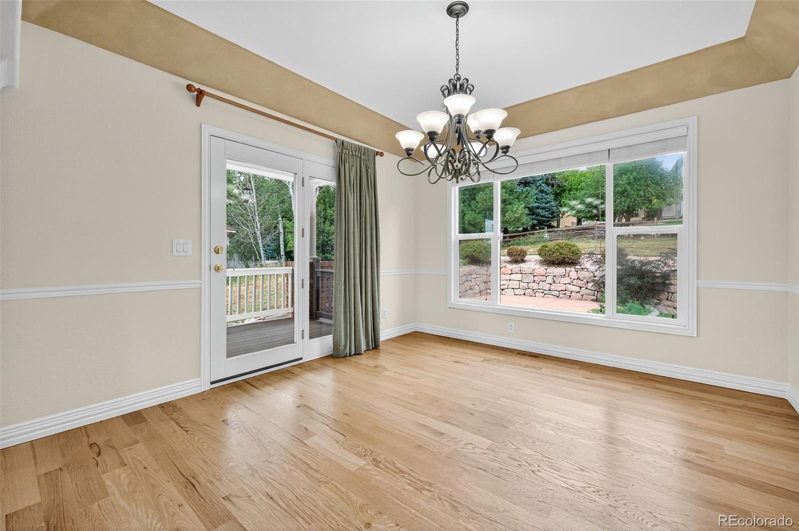 8389 Owl Roost Court Parker, CO 80134 - Photo 19 of 50 a view of an empty room with wooden floor and a window