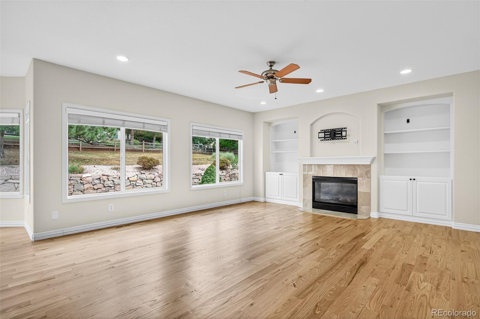 8389 Owl Roost Court Parker, CO 80134 - Photo 22 of 50 a view of an empty room with a fireplace and a window