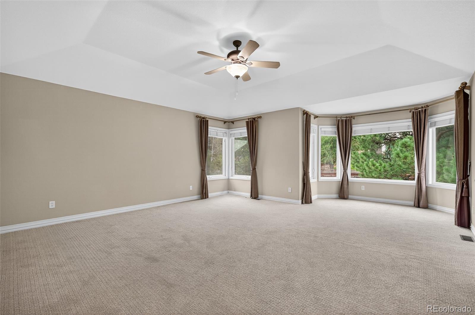 8389 Owl Roost Court Parker, CO 80134 - Photo 36 of 50 a view of a livingroom with a ceiling fan and window
