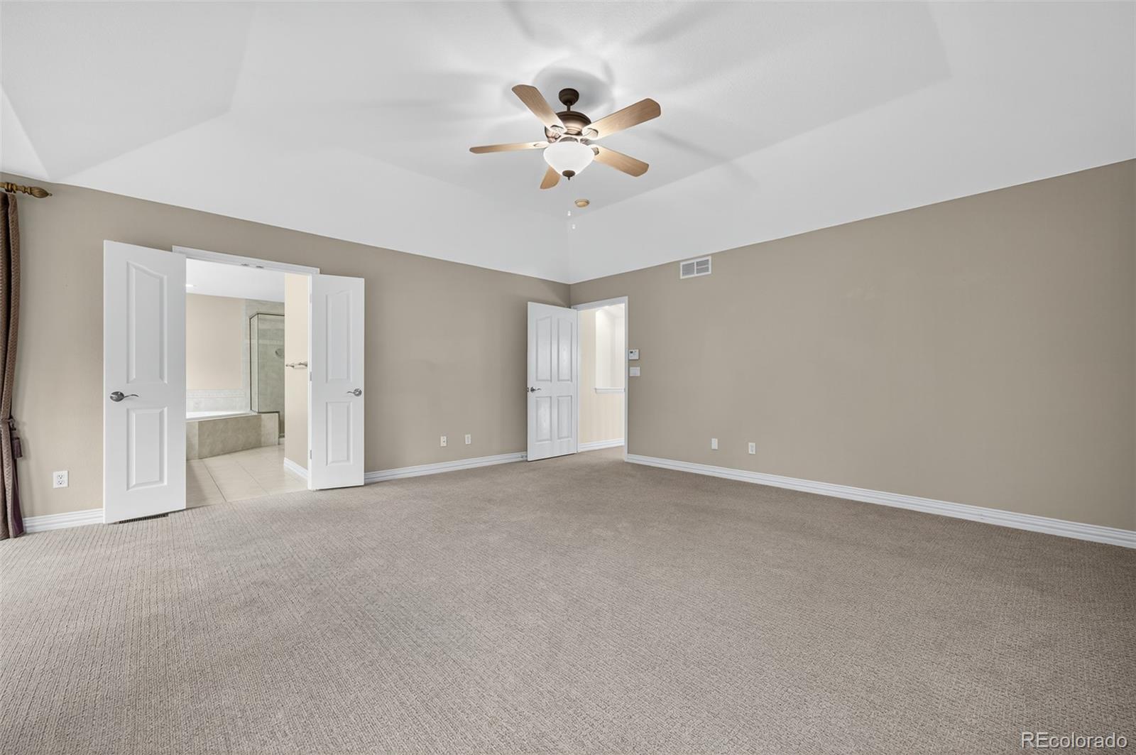 8389 Owl Roost Court Parker, CO 80134 - Photo 38 of 50 a view of an empty room with a ceiling fan