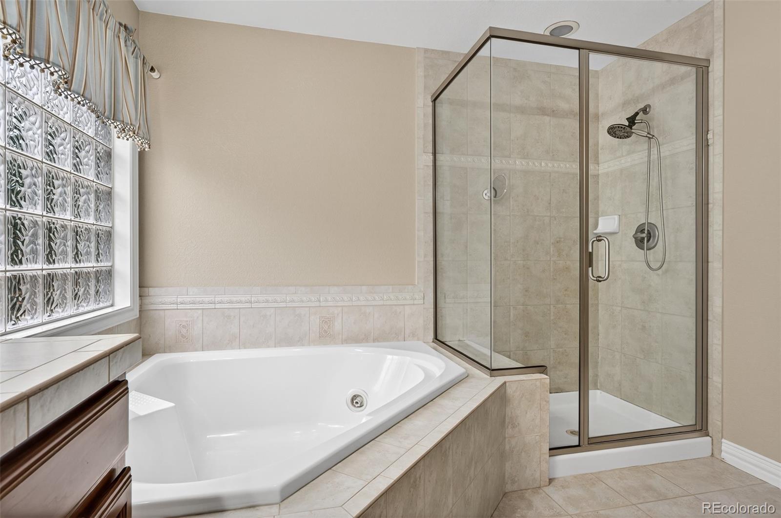 8389 Owl Roost Court Parker, CO 80134 - Photo 41 of 50 a bathroom with a tub and shower