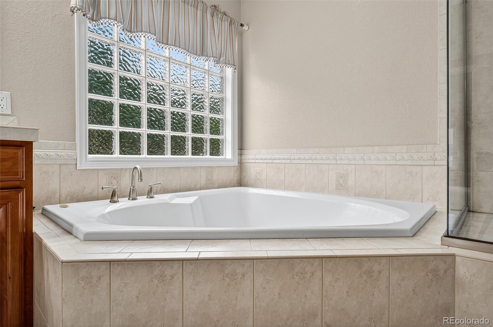 8389 Owl Roost Court Parker, CO 80134 - Photo 42 of 50 a white bath tub sitting next to a white sink