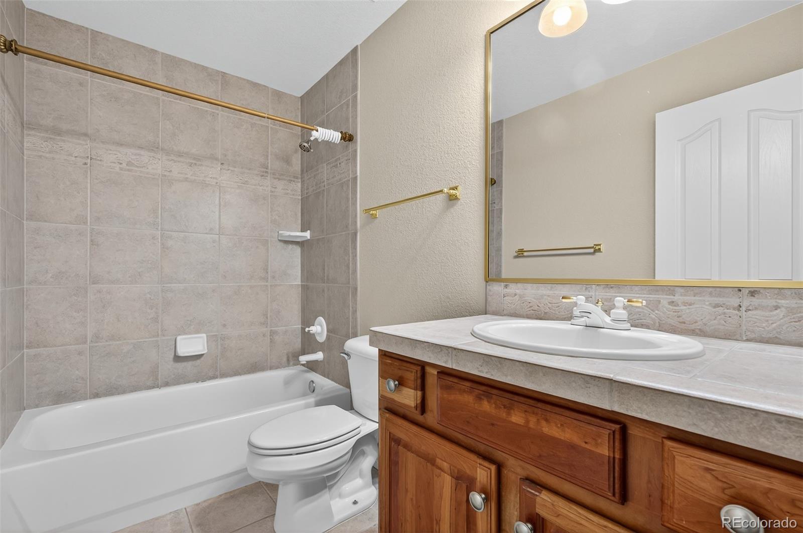 8389 Owl Roost Court Parker, CO 80134 - Photo 47 of 50 a bathroom with a sink a toilet and shower
