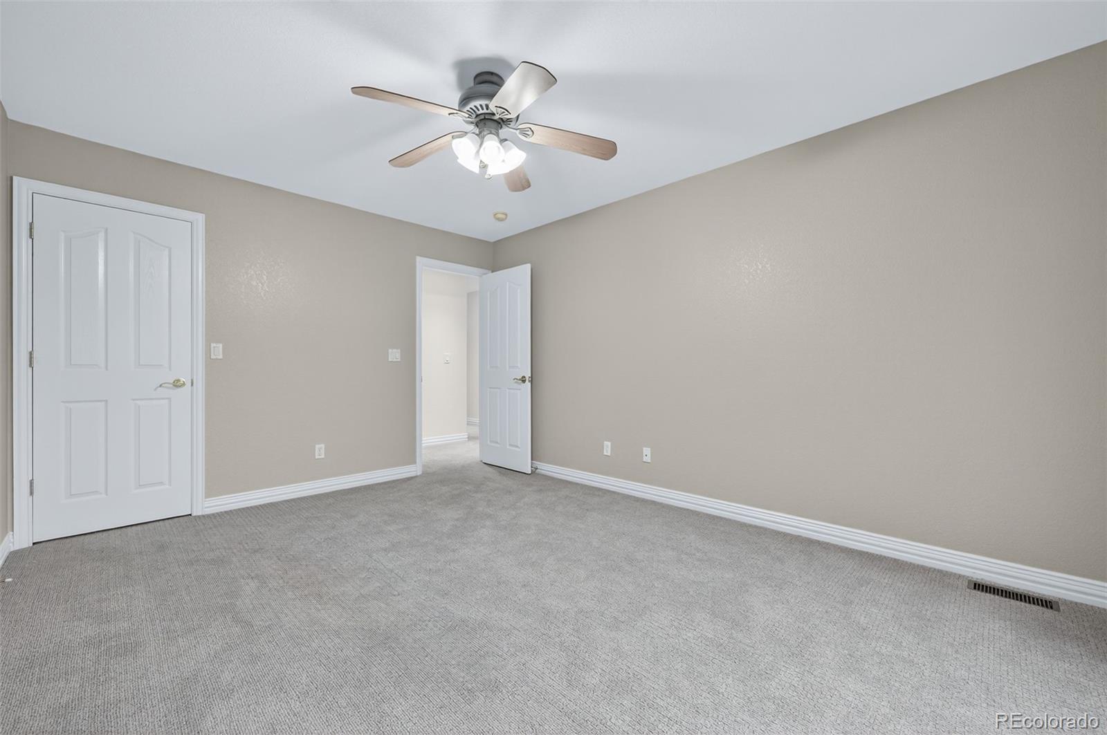 8389 Owl Roost Court Parker, CO 80134 - Photo 49 of 50 a view of an empty room with a chandelier fan