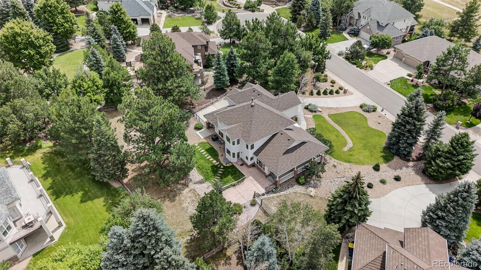 8389 Owl Roost Court Parker, CO 80134 - Photo 8 of 50 an aerial view of a house with a yard and trees
