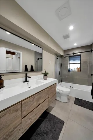 a bathroom with a toilet a sink and mirror