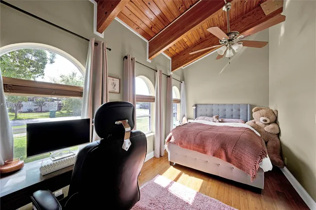 a bedroom with a bed window and lamp