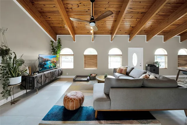 a large living room with furniture and a chandelier